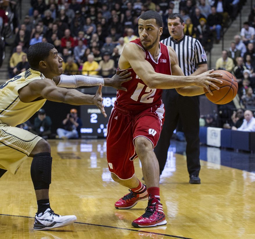 Wisconsin's Traevon Jackson (12) is pressured by Purdue's Ronnie Johnson (3) in the first half of an NCAA college basketball game, Saturday, Jan. 25, 2014, in West Lafayette, Ind. (AP Photo/Doug McSchooler)