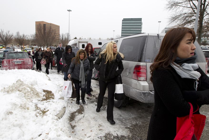 People are evacuated from the Mall in Columbia, Md., after a shooting at the mall on Saturday Jan. 25, 2014 in Howard County, Md. Police in Maryland say three people died Saturday in a shooting at a mall in suburban Baltimore, including the presumed gunman. ( AP Photo/Jose Luis Magana)