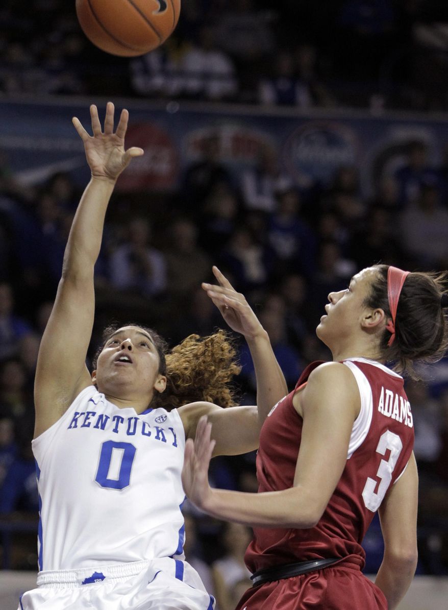 Kentucky's Jennifer O'Neill (0) shoots as Arkansas' McKenzie Adams (3) defends during the first half of NCAA college basketball game, Sunday, Jan. 26, 2014, in Lexington, Ky. (AP Photo/James Crisp)