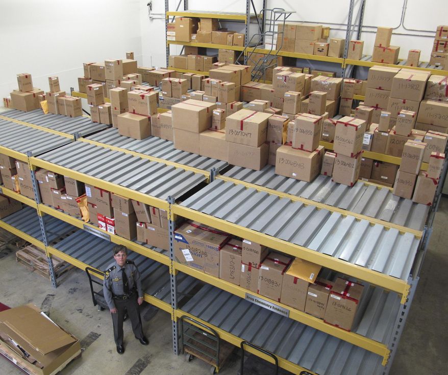 In this Thursday, Jan. 16, 2014 photo, Staff Lt. Anne Ralston stands in a storage area for boxes of drugs already tested by the State Highway Patrol's crime lab in Columbus, Ohio. The patrol renovated the lab and added staff to help reduce a backlog of cases awaiting testing. (AP Photo/Kantele Franko)