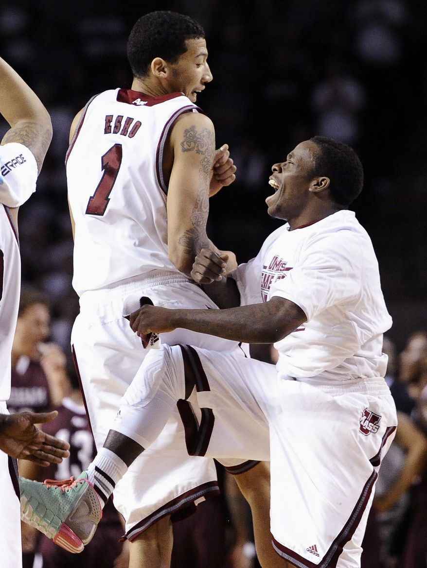 Massachusetts' Maxie Esho, left, and Chaz Williams react during the second half of an NCAA college basketball game against Fordham, Sunday, Jan. 26, 2014, in Amherst, Mass. Massachusetts won 90-52. (AP Photo/Jessica Hill)