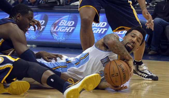 Denver Nuggets small forward Wilson Chandler grabs a loose ball against the Indiana Pacers during the third quarter of an NBA basketball game Saturday, Jan. 25, 2014, in Denver. (AP Photo/Jack Dempsey)