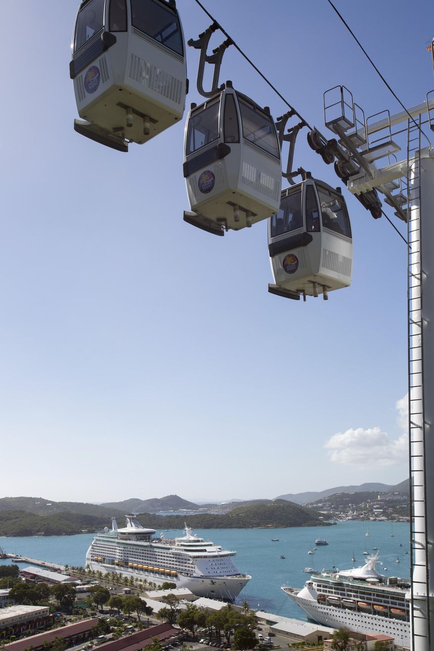The Royal Caribbean International's Explorer of the Seas crusie ship, bottom left, is docked at Charlotte Amalie Harbor in St. Thomas, U. S. Virgin Islands, Sunday, Jan. 26, 2014. U.S. health officials have boarded the cruise ship to investigate an illness outbreak that has stricken at least 300 people with gastrointestinal symptoms including vomiting and diarrhea. (AP Photo/Thomas Layer)