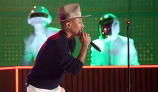 Pharrell Williams performs with Thomas Bangalter, background left, and Guy-Manuel de Homem-Christo of Daft Punk, at the 56th annual Grammy Awards at Staples Center on Sunday, Jan. 26, 2014, in Los Angeles. (Photo by Matt Sayles/Invision/AP)