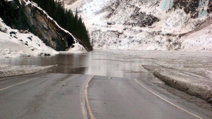 This Jan. 24, 201 4 photo provided by the Alaska Department of Transportation & Public Facilities shows multiple avalanches that crossed the Richardson Highway in the Thompson Pass region of Valdez, Alaska, causing flooding. Alaska highway officials say the only highway into the city of 4,100 people will be closed until further notice, for at least a week, if not much longer. (AP Photo/Alaska Department of Transportation & Public Facilities)