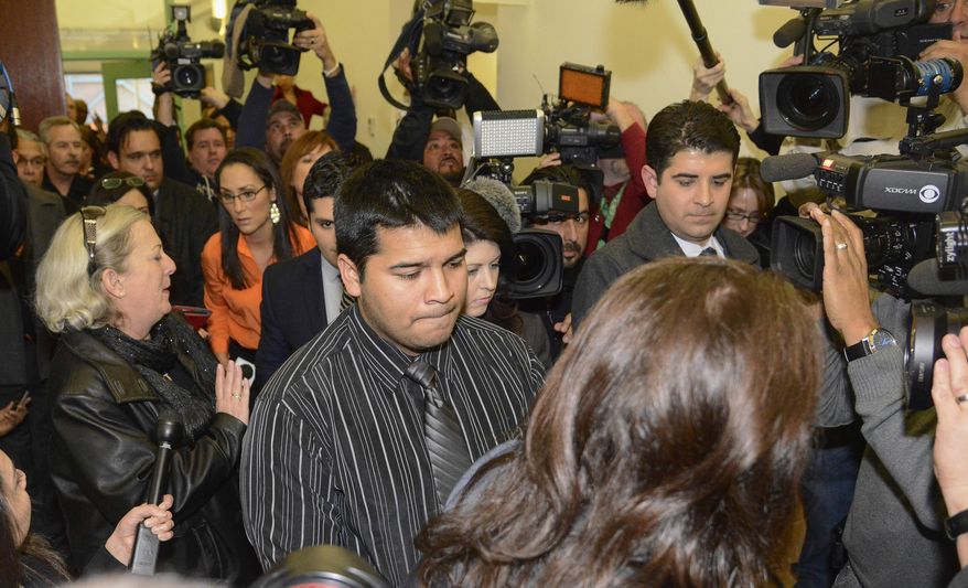 Erick Munoz, husband of Marlise Munoz, is escorted out of court by his attorney Heather L. King, right, Friday, Jan. 24, 2014 in Fort Worth, Texas. The court ruled in Munoz's favor and to remove his brain-dead pregnant wife from life support. Judge R. H. Wallace Jr. issued the ruling in the case of Marlise Munoz. John Peter Smith Hospital in Fort Worth has been keeping Munoz on life support against her family's wishes. The judge gave the hospital until 5 p.m. CST Monday to remove life support. (AP Photo/Tim Sharp)