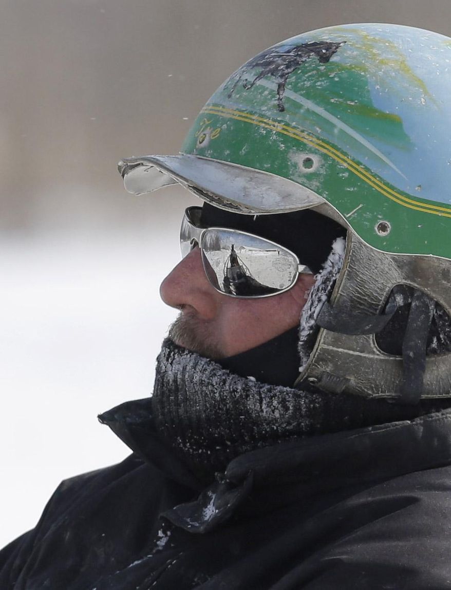 A trainer drives a horse and buggy around the track at the Hard Rock Rocksino Northfield Park Monday, Jan. 27, 2014, in Northfield, Ohio. The National Weather Service put most of Ohio under a wind chill warning Monday as temperatures dropped and forecasters predicted wind chills that were well below zero and expected to dip even more on Tuesday. They warned of wind gusts reaching 35 to 45 mph, with blizzard conditions in some rural areas.(AP Photo/Tony Dejak)
