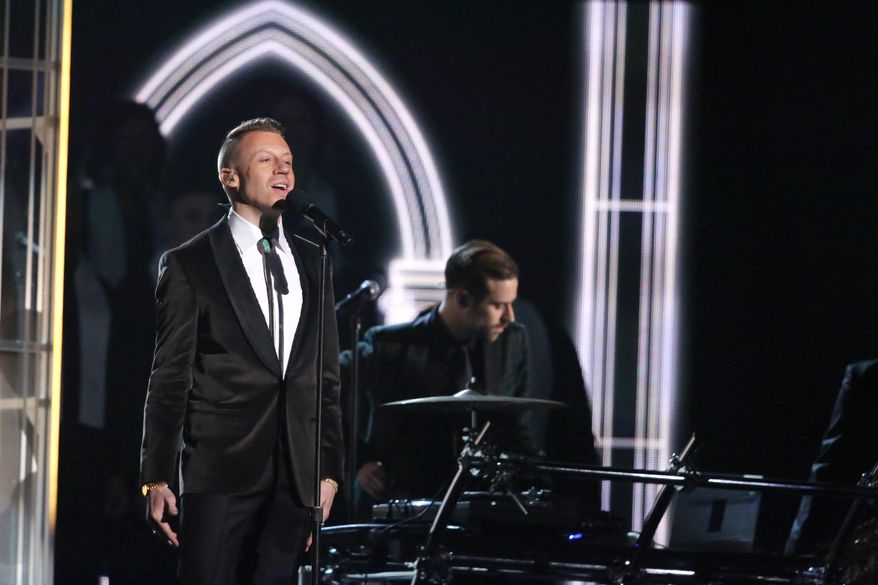 Macklemore performs "Same Love" on stage at the 56th annual Grammy Awards at Staples Center on Sunday, Jan. 26, 2014, in Los Angeles. (Photo by Matt Sayles/Invision/AP)