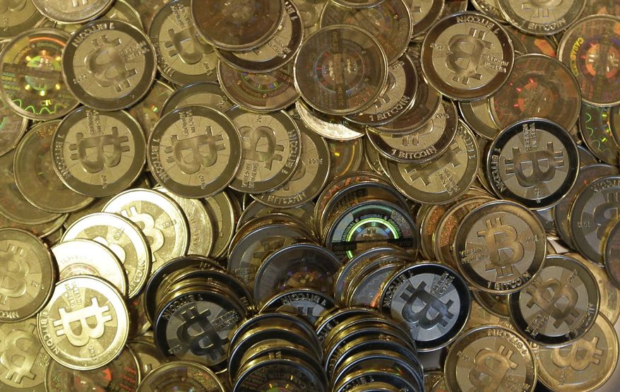 ** FILE ** This April 3, 2013, file photo shows bitcoin tokens in Utah. (AP Photo/Rick Bowmer, File)