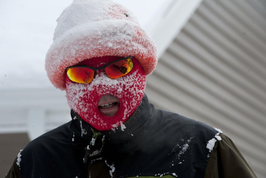 CORRECTS TRANS REFERENCE TO MIJAC102 - Anthony LaPorte of Jackson is covered in snow after snowblowing out his driveway and sidewalk on the northeast side Jackson, Mich., on Monday, Jan. 27, 2014. Gusting winds and blowing snow caused whiteout conditions Monday that made travel treacherous on some Michigan roadways, and hundreds of schools closed because of the severe weather. (AP Photo/Jackson Citizen Patriot, J. Scott Park)
