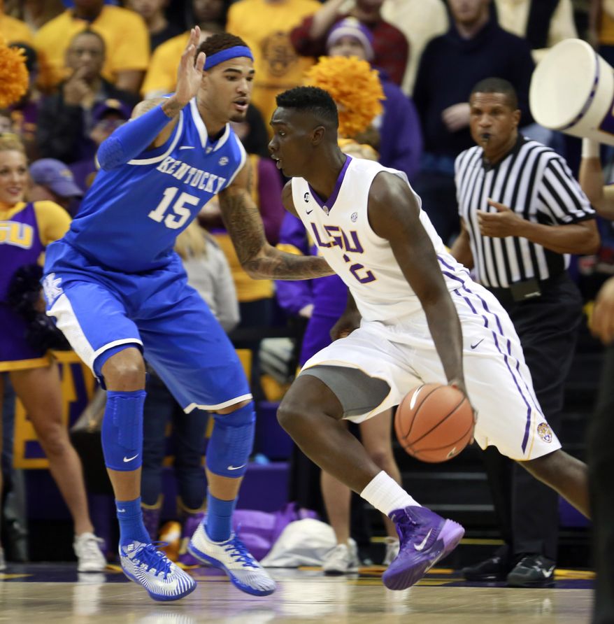 LSU forward Johnny O'Bryant III (2) drives against Kentucky forward Willie Cauley-Stein (15) during the first half of an NCAA college basketball game in Baton Rouge, La., Tuesday, Jan. 28, 2014. (AP Photo/Tim Mueller)