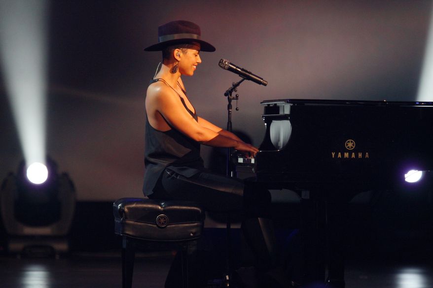 Alicia Keys performs at the night that changed America: a Grammy salute to the Beatles, on Monday, Jan. 27, 2014, in Los Angeles. (Photo by Zach Cordner/Invision/AP)