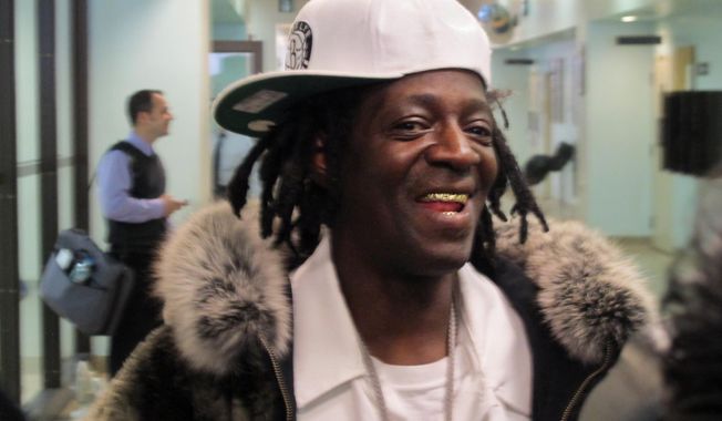 Flavor Flav speaks with reporters following an appearance in Nassau County District Court in Hempstead, N.Y., on Tuesday, Jan. 28, 2014. The rapper, whose real name is William Drayton, was in court on charges he was speeding and driving with a suspended license en route to his mother&#x27;s funeral in Long Island on Jan. 9. Drayton pleaded not guilty Tuesday and was released without bail. (AP Photo/Frank Eltman)