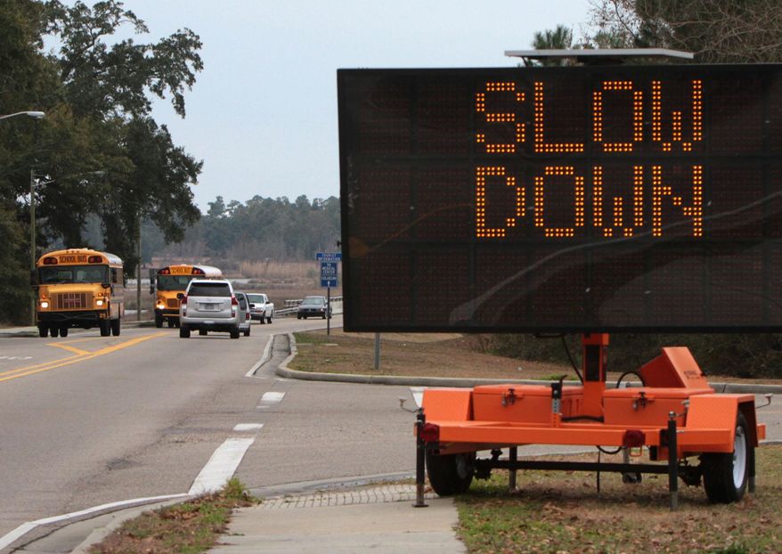 A warns motorists to slow down on the Popp's Ferry bridge in Biloxi, Miss., on Monday Jan. 27, 2014. Bridges are expected to ice over on Tuesday and Wednesday during a winter storm in the area. The sign was put out on Friday when another winter storm left ice on area bridges causing multiple auto accidents. (AP Photo/Sun Herald, John Fitzhugh)