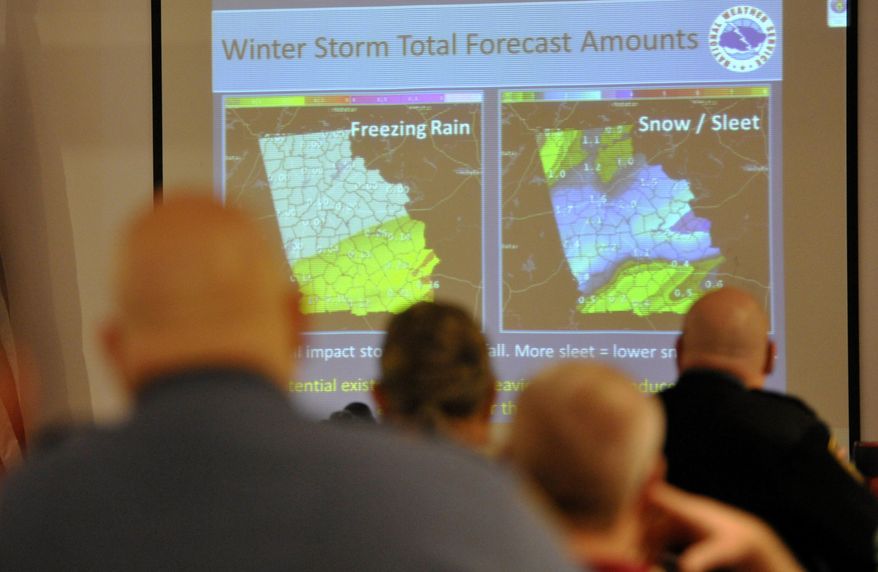 Representatives from Houston County's Houston County's law enforcement agencies, Red Cross, hospitals, and school system attend a National Weather Service weather briefing Tuesday, Jan. 28, 2014 in Warner Robins, Ga. Across the Deep South, residents stocked up on fuel and groceries, schools and offices closed, and road crews were at the ready as a storm moved in Tuesday from the central U.S., threatening to bring snow, ice and subzero temperatures to a region more accustomed to air conditioners and sunscreen than parkas and shovels. (AP Photo/The Macon Telegraph, Woody Marshall)