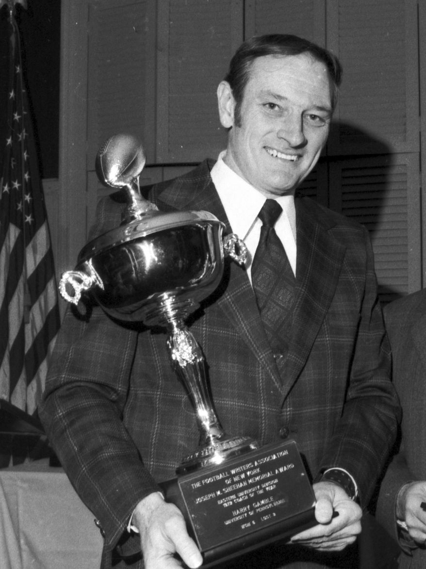 FILE - In this Feb. 5, 1973, file photo, University of Pennsylvania football coach Harry Gamble holds his trophy presented by the Football Writers Association of New York in New York. Gamble, who coached the Philadelphia Eagles as well as Lafayette, Penn and New Jersey high school teams before retiring as the Eagles' president, died Tuesday, Jan. 28, 2014, the Eagles said in a statement. He was 83. (AP Photo/John J. Lent, File)