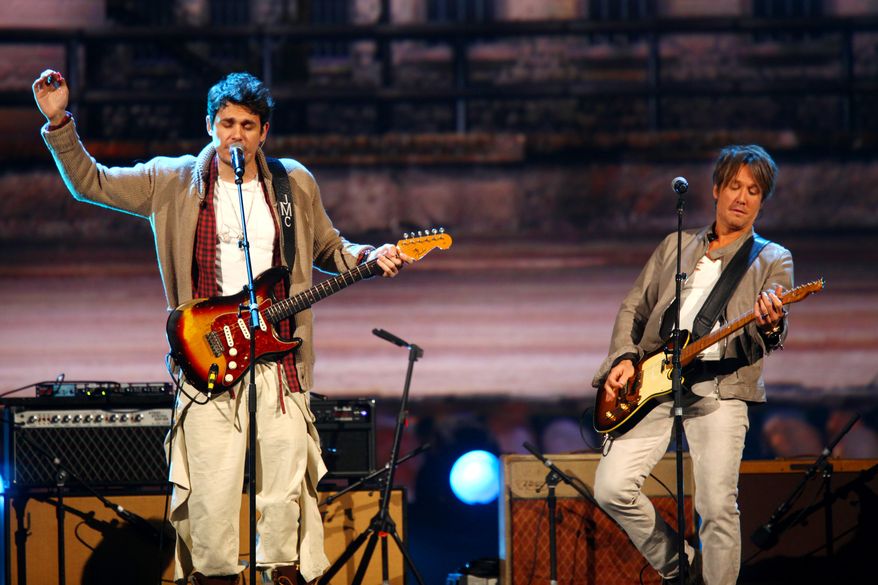 John Mayer, left, and Keith Urban perform at the night that changed America: a Grammy salute to the Beatles, on Monday, Jan. 27, 2014, in Los Angeles. (Photo by Zach Cordner/Invision/AP)