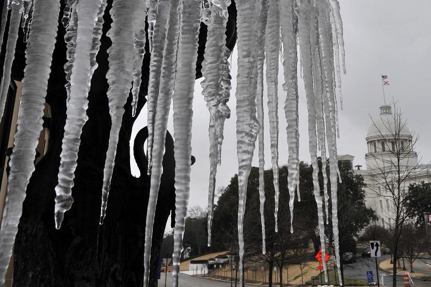 Water runs through a frozen fountain outside the Alabama Association of Realtors across from the Capitol Tuesday, Jan. 28, 2014, in Montgomery, Ala. A fast-moving, unexpectedly severe winter storm blanketed much of Alabama with a treacherous layer of frozen precipitation Tuesday. (AP photo/AL.com, Julie Bennett)
