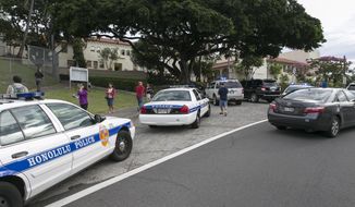 Police respond to the campus of Roosevelt Hight School, after a shooting, Tuesday, Jan. 28, 2014, in Honolulu.  A police officer shot a 17-year-old runaway in the wrist at the high school after the teen cut one officer with a knife and punched two others, authorities said.  State Department of Education spokeswoman Donalyn Dela Cruz said the boy showed up Tuesday morning at Roosevelt High School. Officials there recognized him as a runaway who was not registered for classes, and called police.  Maj. Richard Robinson, commander of the Honolulu Police Department’s Criminal Investigations Division, said the boy lunged at officers who arrived at the public high school near downtown Honolulu and tried to take him into custody. (AP Photo/Marco Garcia)
