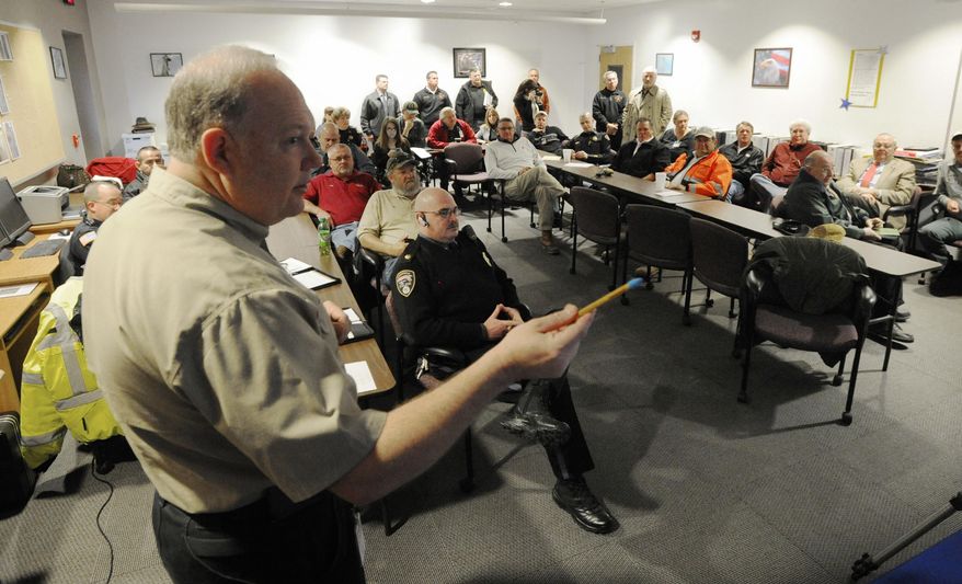 Houston County Emergency Management Agency Director Jimmy Williams leads a meeting of representatives from Houston County's Houston County's law enforcement agencies, Red Cross, hospital, RABF, and school system after a National Weather Service weather briefing Tuesday, Jan. 28, 2014 in Warner Robins, Ga. Across the Deep South, residents stocked up on fuel and groceries, schools and offices closed, and road crews were at the ready as a storm moved in Tuesday from the central U.S., threatening to bring snow, ice and subzero temperatures to a region more accustomed to air conditioners and sunscreen than parkas and shovels. (AP Photo/The Macon Telegraph, Woody Marshall)