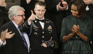 Army Ranger Sgt.1st Class Cory Remsburg acknowledges applause from first lady Michelle Obama and others during President Barack Obama&#39;s State of the Union address on Capitol Hill in Washington, Tuesday Jan. 28, 2014. (AP Photo/J. Scott Applewhite)