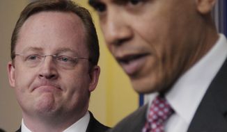 **FILE** President Barack Obama, right, acknowledges outgoing White House Press Secretary Robert Gibbs, left, during the daily news briefing at the White House in Washington, Friday, Feb., 11, 2011. Gibbs stepped down from the post after two years as Obama&#39;s top spokesman. (AP Photo/Carolyn Kaster)