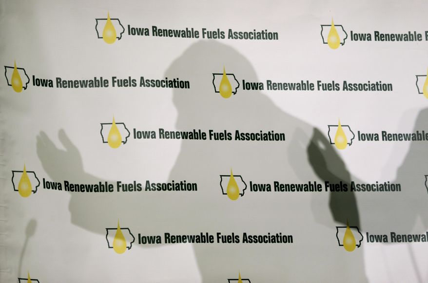 Iowa Gov. Terry Branstad casts a shadow on a backdrop as he speaks during the Iowa Renewable Fuels Association Summit, Tuesday, Jan. 28, 2014, in Altoona, Iowa. Branstad says he feels momentum is with Iowa and other farm states pushing the EPA to reverse a plan to cut the amount of biofuels blended into gasoline this year. (AP Photo/Charlie Neibergall)