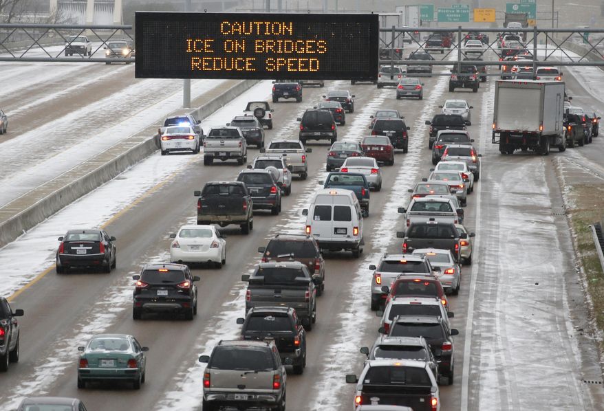 Traffic creeps along I-55 in north Jackson, Miss., Tuesday, Jan. 28, 2014 as ice and snow flurries cause difficult driving conditions. A severe winter storm is expected to hit the state bringing ice and snow to the Gulf Coast. (AP Photo/Rogelio V. Solis)