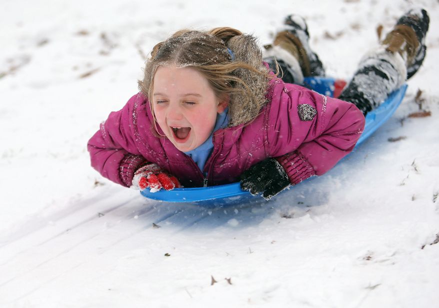 Lily Turcotte-Keen, 8, screams as she sleds down a hill at Grant Park after getting out of school early due to the snow storm on Tuesday, Jan. 28, 2014, in Atlanta. A winter storm that would probably be no big deal in the North all but paralyzed the Deep South on Tuesday, bringing snow, ice and teeth-chattering cold, with temperatures in the teens in some places. (AP Photo/Atlanta Journal-Constitution, Ben Gray)