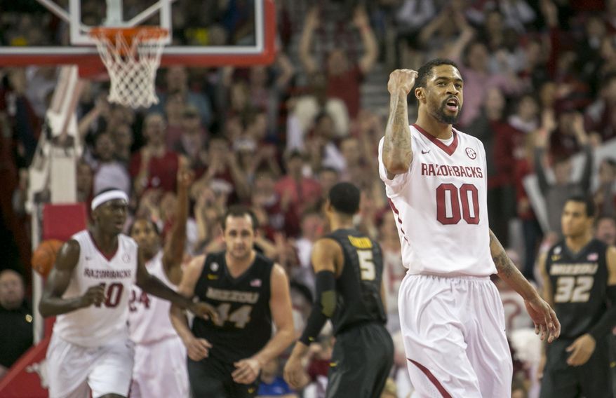 Arkansas guard Rashad Madden (00) celebrates after scoring a 3-point shot to take the lead during the second half of an NCAA college basketball game against Missouri on Tuesday, Jan. 28, 2014, in Fayetteville, Ark. Madden led Arkansas in scoring with 20 points as Missouri defeated Arkansas 75-71. (AP Photo/Gareth Patterson)