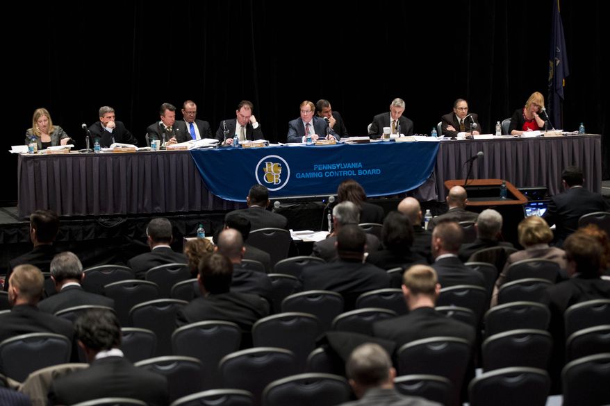 Members of the Pennsylvania Gaming Control Board listen to developer Bart Blatstein make his pitch to the for Philadelphia's second casino license during a public hearing Tuesday, Jan. 28, 2014, in Philadelphia. State law allows the city a second casino, and the five applicants are making their final pitches this week to state regulators. SugarHouse Casino contends the market is already saturated and has asked the board to sit on the license. (AP Photo/Matt Rourke)