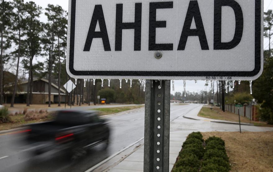 Icicles hang from a road sign on U.S. 190 in Mandeville, La., as the sleet and rain of the winter storm moves in Tuesday, Jan. 28, 2014. (AP Photo/ NOLA.com/The Times-Picayune, G. Andrew Boyd) MAGS OUT; NO SALES; USA TODAY OUT; THE BATON ROUGE ADVOCATE OUT.