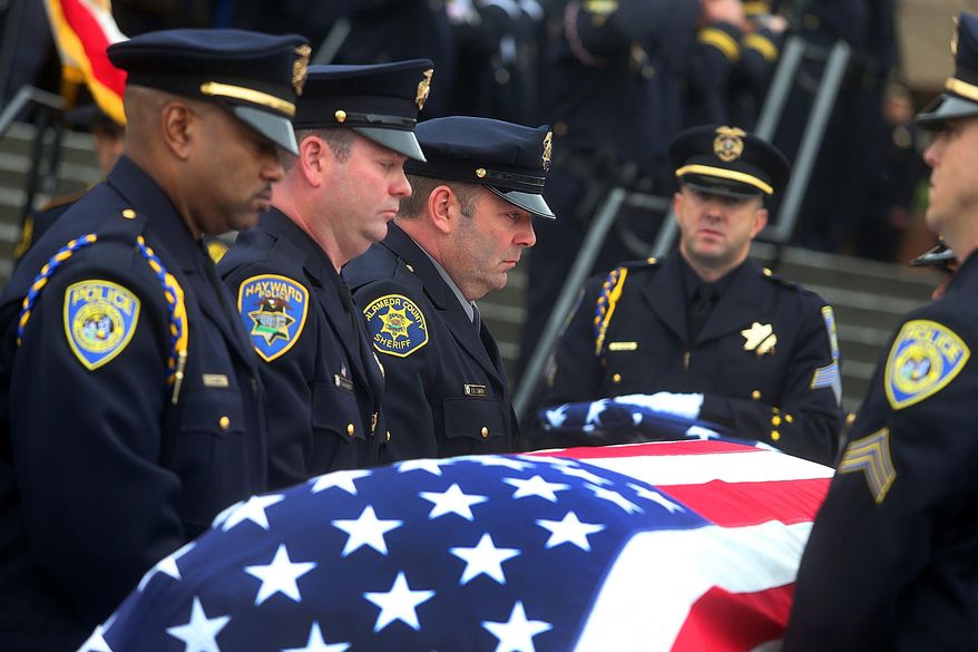 Pallbearers carry the casket of Bay Area Rapid Transit police Sgt. Tom Smith Jr. into the chapel during funeral services at the Neighborhood Church on Wednesday, Jan 29, 2014, in Castro Valley, Calif. Smith Jr.'s brother-in-law Hayward Police Officer Todd Shaheen is second to left, and brother Alameda County Sheriff Deputy Ed Smith is third from left. Smith, 42, died last week after being shot by fellow BART officer Michael Maes during an apartment search at an apartment complex in Dublin, Calif. (AP Photo/Bay Area News Group, Aric Crabb) MANDATORY CREDIT.