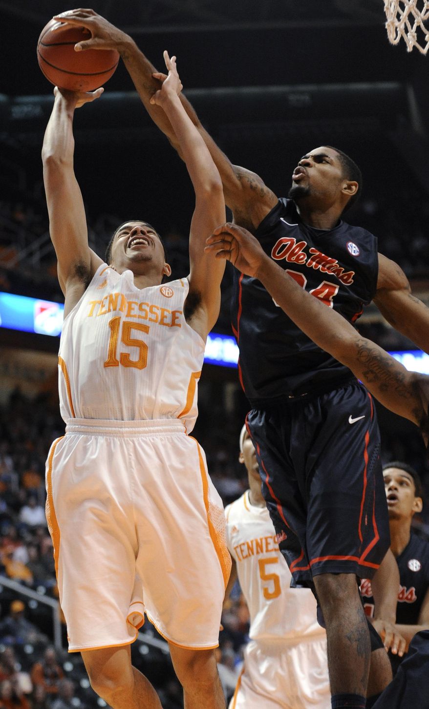 Mississippi forward Aaron Jones (34) blocks a layup attempt by Tennessee guard Darius Thompson (15) during the first half of an NCAA college basketball game Wednesday, Jan. 29, 2014, in Knoxville, Tenn. (AP Photo/Knoxville News Sentinel, Adam Lau)