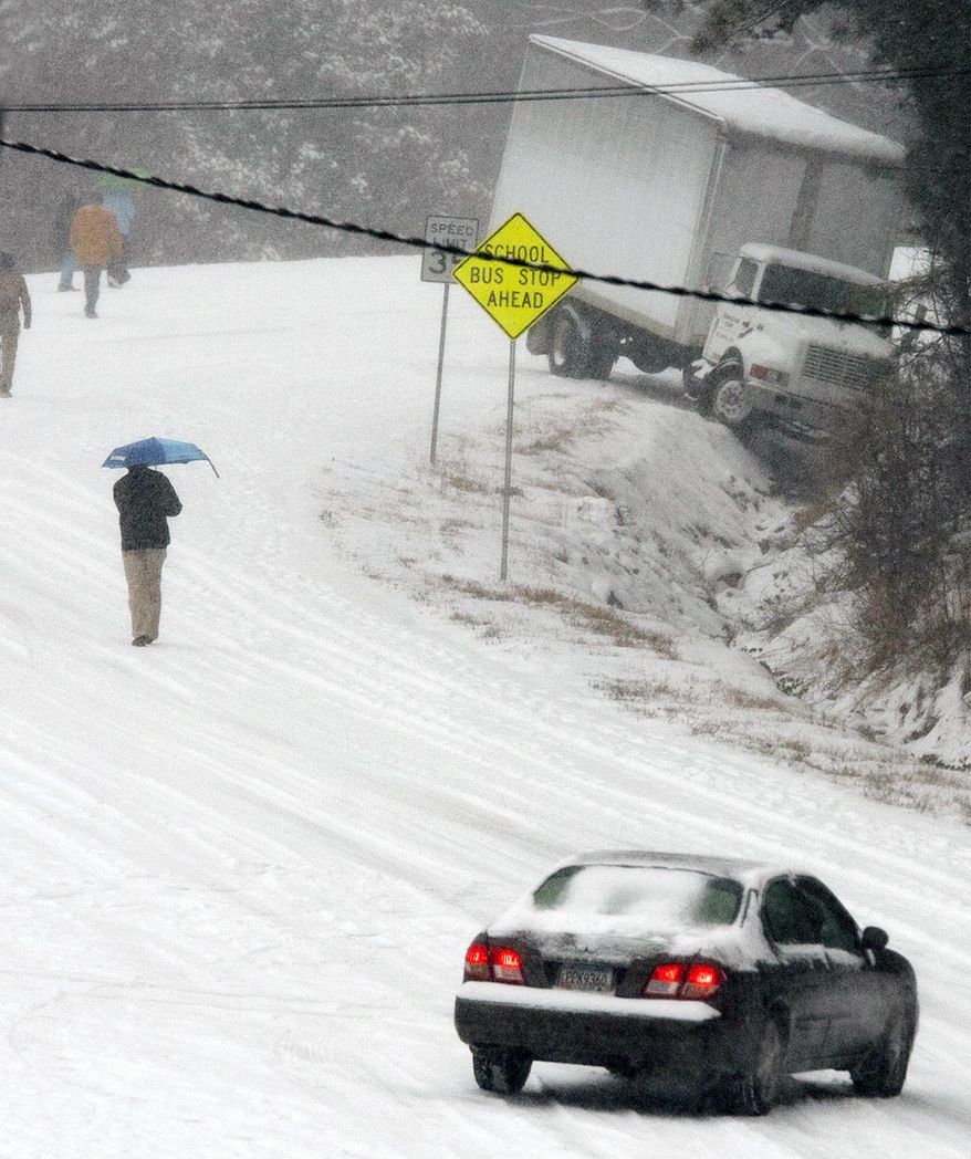 Motorists abandon their vehicles on Georgia State Highway 140 near the bottom of the large hill, Tuesday, Jan. 28, 2014 in Canton, Ga. A winter storm that would probably be no big deal in the North all but paralyzed the Deep South on Tuesday, bringing snow, ice and teeth-chattering cold, with temperatures in the teens in some places. (AP Photo/The Marietta Daily Journal, Kelly J. Huff) ATLANTA JOURNAL CONSTITUTION OUT; MAGS OUT; NO SALES