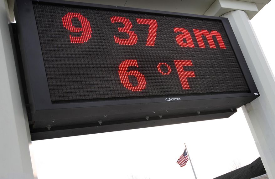 The American Flag could be known as Cold Glory as it flys on top a bank building where the thermometer reads six degrees fahrenheit in Frederick County, Va. Tuesday, Jan. 28, 2014. (AP Photo, The Winchester Star, Jeff Taylor)