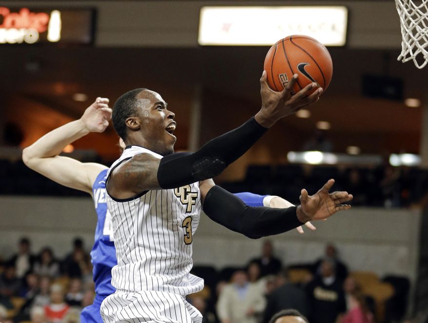 Central Florida's Isaiah Sykes (3) makes a basket as he gets past Memphis' Austin Nichols, back left, during the second half of an NCAA basketball game in Orlando, Fla., Wednesday, Jan. 29, 2014. Memphis won 69-59.(AP Photo/John Raoux)