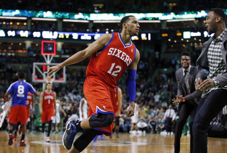 Philadelphia 76ers forward Evan Turner (12) runs toward his bench in celebration of his buzzer-beating shot at the end of an NBA basketball game against the Boston Celtics in Boston, Wednesday, Jan. 29, 2014. The 76ers won 95-94. (AP Photo/Elise Amendola)