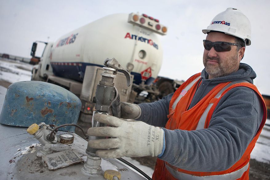 In this Jan. 22, 2014 photo, AmeriGas employee Jay Carlson prepares to remove a hose after filling a tank with propane near Galesburg, Ill. On Monday, Jan. 27, 2014, Illinois Gov. Pat Quinn declared a propane supply emergency in Illinois. Wet fall weather and recent cold spells have combined to put a pinch on Illinois' propane supplies, causing distribution problems across the state. (AP Photo/The Register-Mail, Steve Davis)