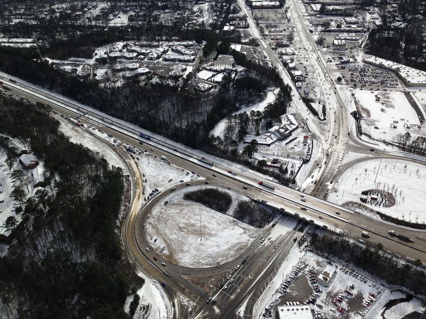 In this aerial view Hoover Ala., vehicles sit on and near the road Wednesday, Jan. 29, 2014, after a winter snow storm swept the area Tuesday. Overnight, the South saw fatal crashes and hundreds of fender-benders. Jackknifed 18-wheelers littered Interstate 65 in central Alabama. Some commuters pleaded for help via cellphones while still holed up in their cars, while others trudged miles home, abandoning their vehicles outright. (AP Photo/Jay Reeves)