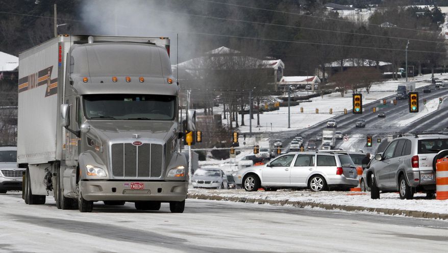 Icy conditions and abandoned vehicles has traffic at a stand still along Highway 280 on Wednesday, Jan. 29, 2014, in Inverness, Ala. A Winter storm caught much of Alabama off guard and stranded thousands of people at work, schools and on roadways. (AP Photo/Butch Dill)