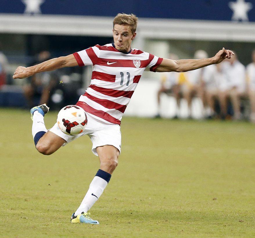 FILE - In this July 24, 2013, United States' Stuart Holden attempts a shot on goal during the second half of a Gold Cup semifinal soccer match against Honduras at Cowboys Stadium in Arlington, Texas. Holden is training with the U.S. national team for the first time since tearing his right anterior cruciate ligament during the final of the CONCACAF Gold Cup last July 28. (AP Photo/Brandon Wade, File)