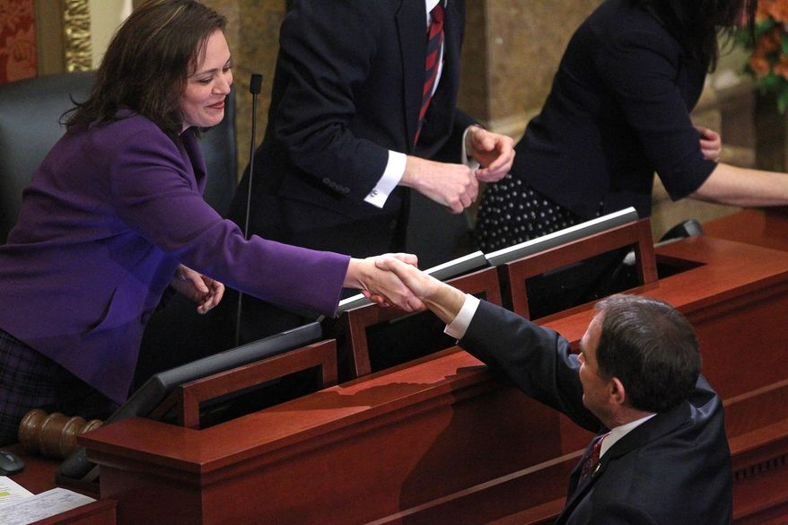 Speaker of the Utah House of Representatives, Becky Lockhart, R-Provo, shakes hands with Utah Gov. Gary Herbert before his fifth annual State of the State address Wednesday, Jan. 29, 2014, in Salt Lake City. Herbert detailed his priorities for 2014 after making air quality and education high-profile issues in his proposed $13.3 billion budget.  (AP Photo/Rick Bowmer)