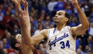 Kansas forward Perry Ellis (34) and Iowa State forward Georges Niang reach for a rebound during the first half of an NCAA college basketball game in Lawrence, Kan., Wednesday, Jan. 29, 2014. (AP Photo/Orlin Wagner)