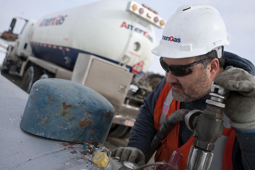 In this Jan. 22, 2014 photo, AmeriGas employee Jay Carlson checks a gauge as he prepares to fill a tank with propane near Galesburg, Ill. On Monday, Jan. 27, 2014, Illinois Gov. Pat Quinn declared a propane supply emergency in Illinois. Wet fall weather and recent cold spells have combined to put a pinch on Illinois' propane supplies, causing distribution problems across the state. (AP Photo/The Register-Mail, Steve Davis)