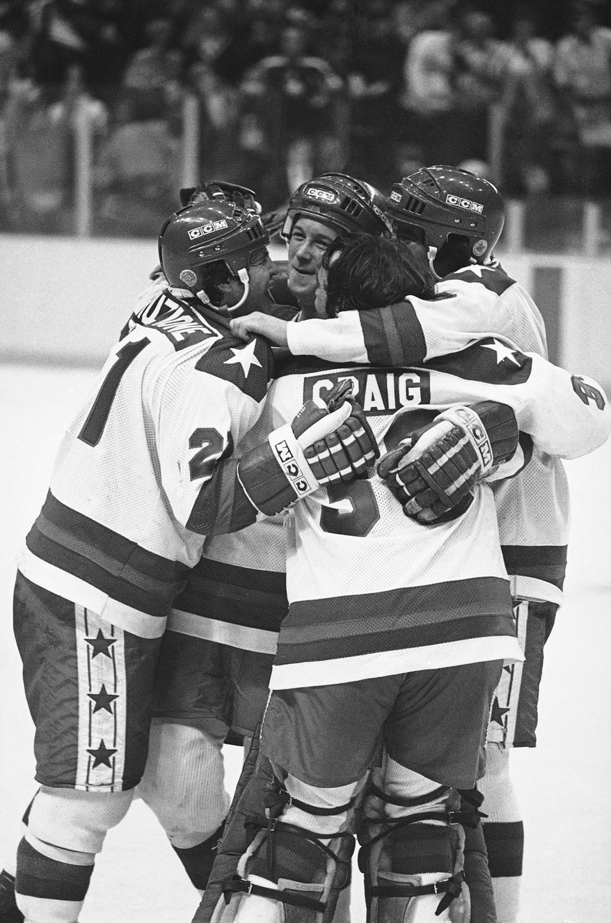 Michael Eruzione, left, scorer of the decisive fourth goal for the USA in the game against USSR on Feb. 22, 1980 in Lake Placid, is embraced by team mates John O&#39;Callahan, David Silk, and goalie James Craig after he brought his team into the lead. (AP Photo)