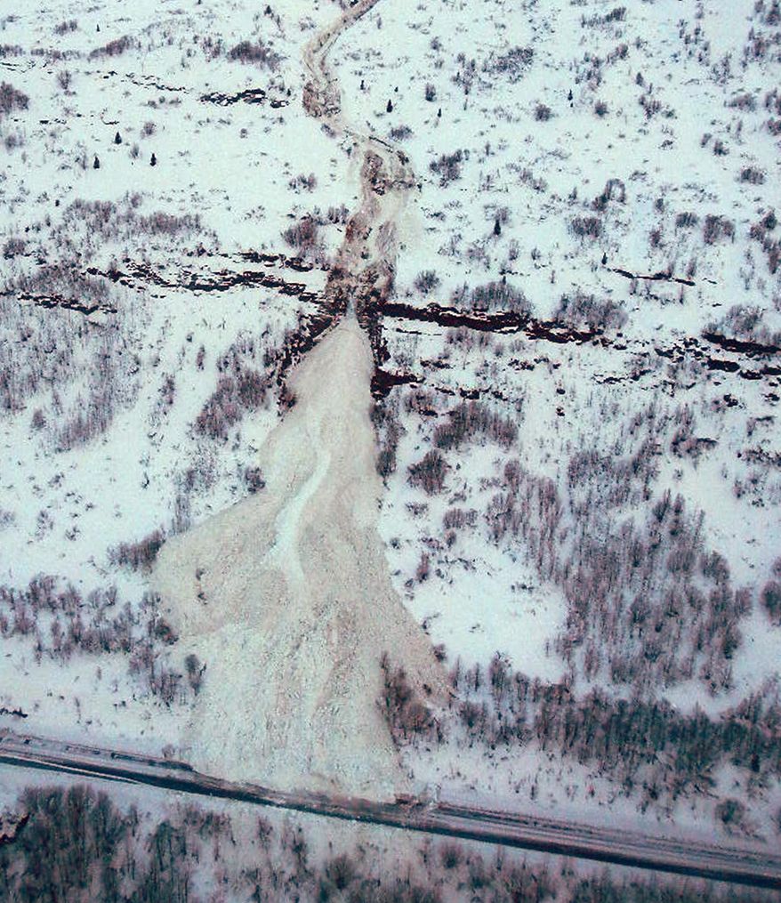 A aerial photo released Wednesday Jan. 29, 2014, by the Alaska Department of Transportation & Public Facilities and made on Jan. 25, 2014,shows the path of an avalanche above the closed Richardson Highway, at Mile 39 near Valdez, Alaska. The Alaska Department of Transportation announced crews had begun removing snow from the major slide, one of many that have blocked the highway, the only road access to Val;dez, the city at the end of the trans-Alaska pipeline.(AP Photo/Alaska DOT&PF)
