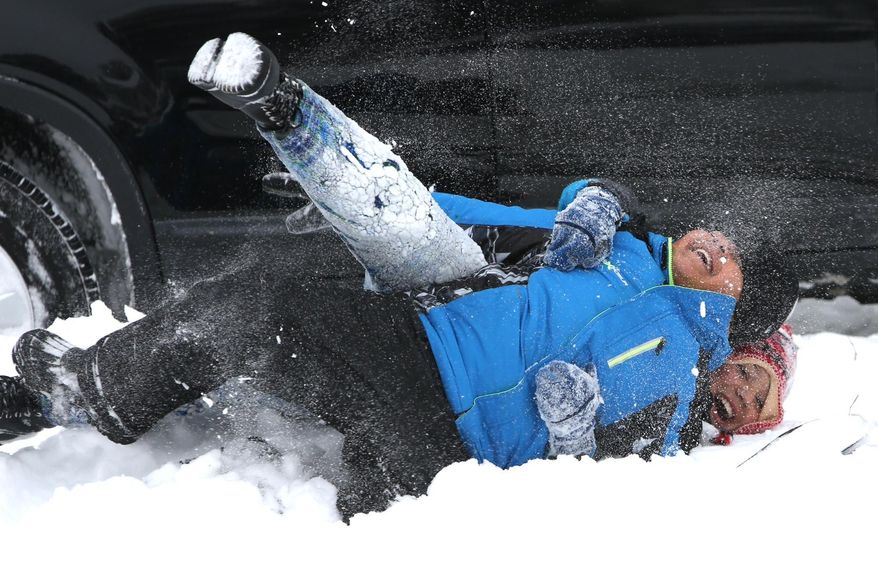Devin Jordan, foreground, and Jaiden Allgood play in the snow near their homes in the South Norfolk area of Chesapeake, Va. on Wednesday, Jan. 29, 2014. The National Weather Service says the Norfolk area averages fewer than three days of snow each winter that result in at least an inch of accumulation. Wednesday marks the fourth day in less than two weeks that at least an inch of snow has fallen. (AP Photo/The Virginian-Pilot, Steve Earley)