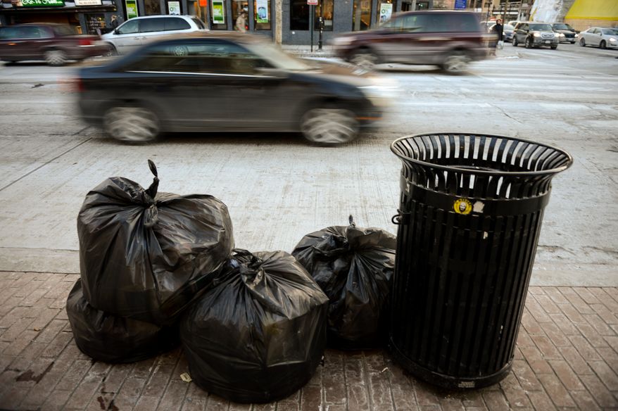 Trash lays on the ground ready to be picked up on the corner of U and 14th Streets in Northwest, Washington, D.C., Wednesday, January 29, 2014. (Andrew Harnik/The Washington Times)