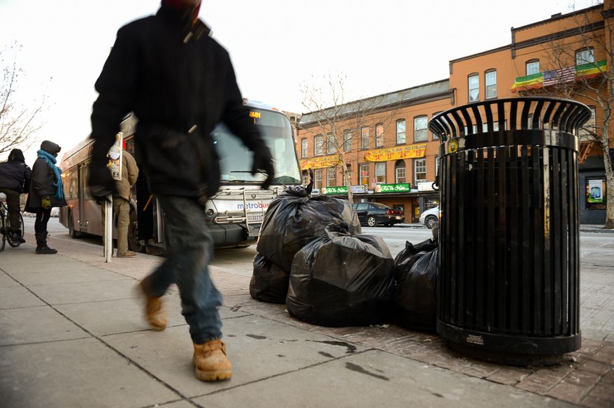 Trash lays on the ground ready to be picked up on the corner of U and 14th Streets in Northwest, Washington, D.C., Wednesday, January 29, 2014. (Andrew Harnik/The Washington Times)